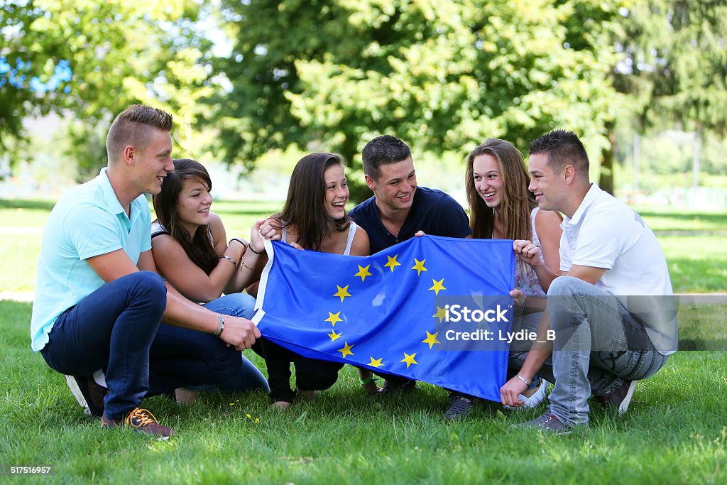 Group of teenagers and Flag Group of teenagers with the European flag European Union Stock Photo