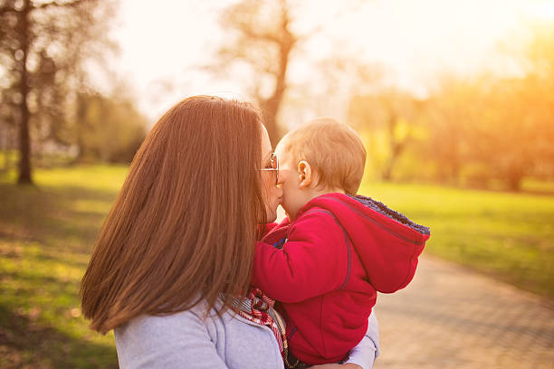 istock Mother kissing baby 517517264