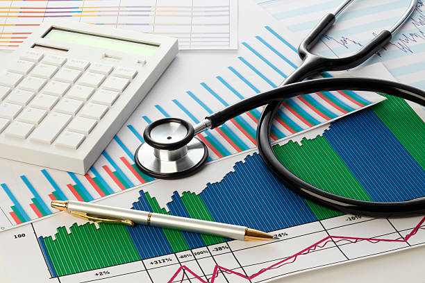 istock Stethoscope with financial statement, calculator and pen　 517517372