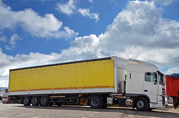 istock white truck and yellow trailer 517517447