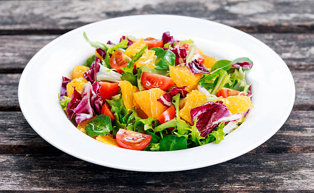 istock Fresh Orange, vegetables salad on wooden table. 517517660