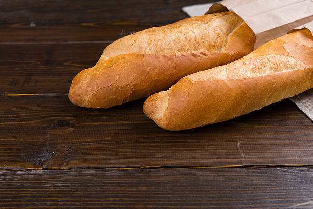 istock Two french bread loaves in bags 517517898