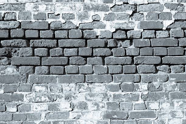 rough old stone texture of an ancient brick wall of monochrome tone