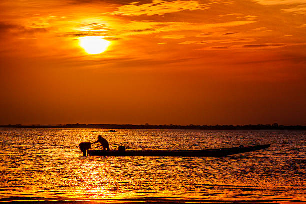 Sunset with fishermen's boats at Orinoco River, Caicara, Venezuela