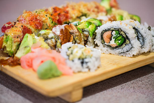 istock Sushi rolls on wooden geta tray 517518712
