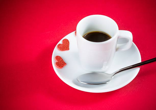istock decorative red hearts near cup of coffee on red table 517519568