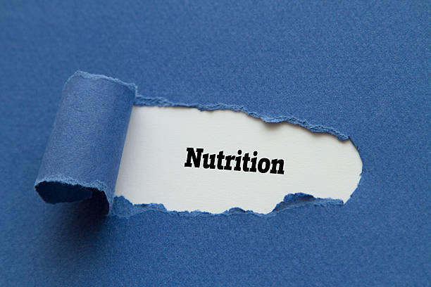 istock Nutrition word written under torn paper. 517520644