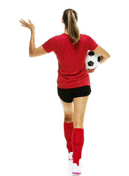 istock Rear view of soccer player waving hand 517521326