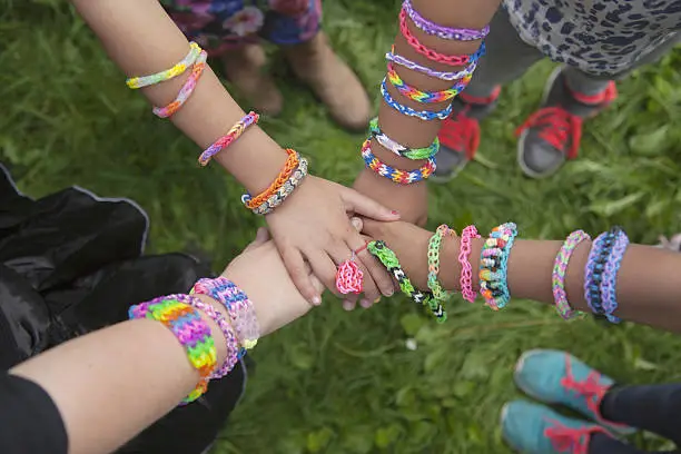 arms with loom bracelets united
