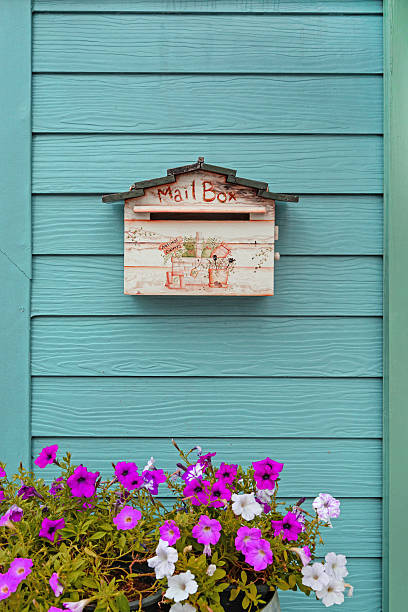 istock mailbox on wooden background with flowers 517521477
