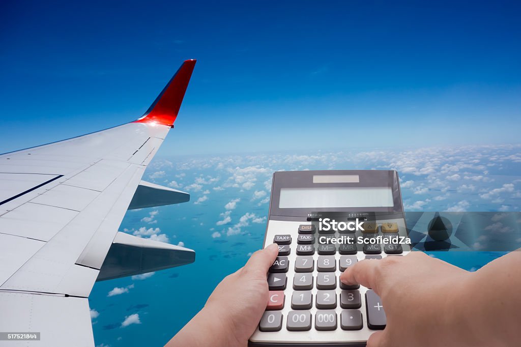 Travel cost calculation concept Travel cost calculation concept by calculator and airplane in background Commercial Airplane Stock Photo