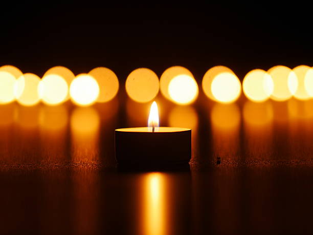 istock One candle flame at night with bokeh 517522245