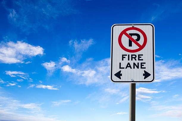 istock Fire Lane No Parking Sign Against Blue Sky 517524928