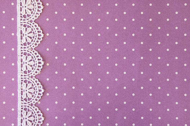 A lace border on a purple paper that can be used as a background for invitations, greeting cards, and scrapbooking