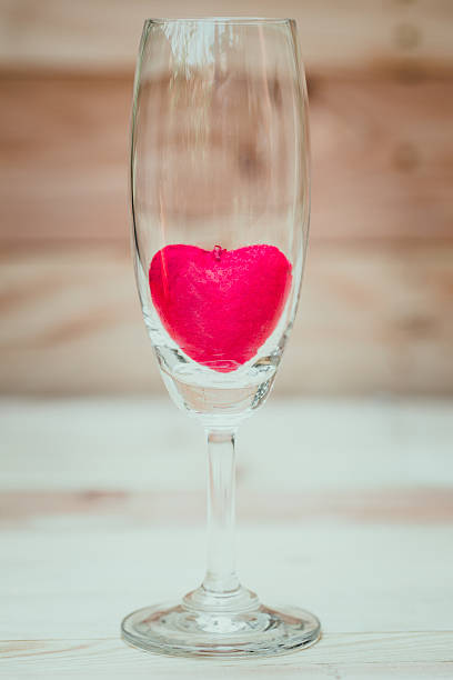 istock red heart inside wine glass on wood background. 517525168