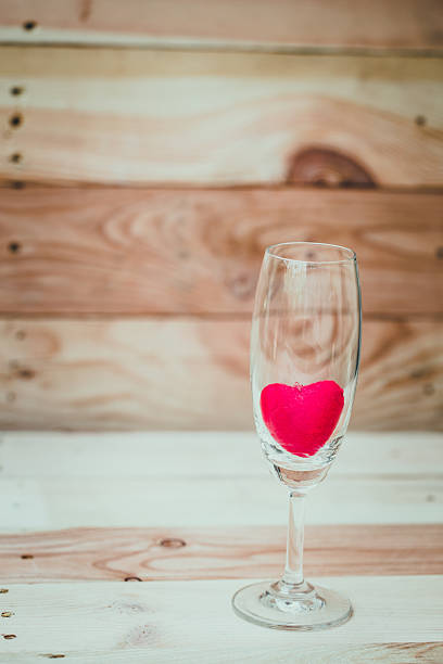 istock red heart inside wine glass on wood background. 517525202