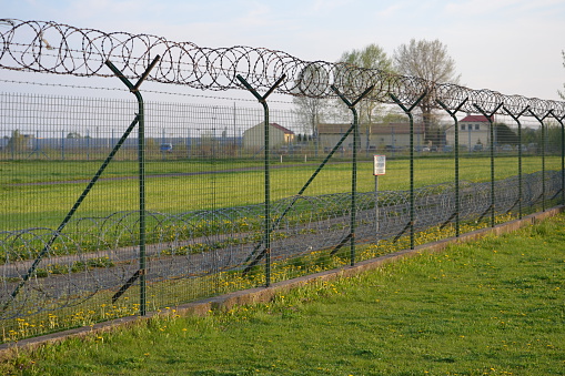 Fence with barbed wire - great for topics like prison, military facility, no escape/ trapped concept.