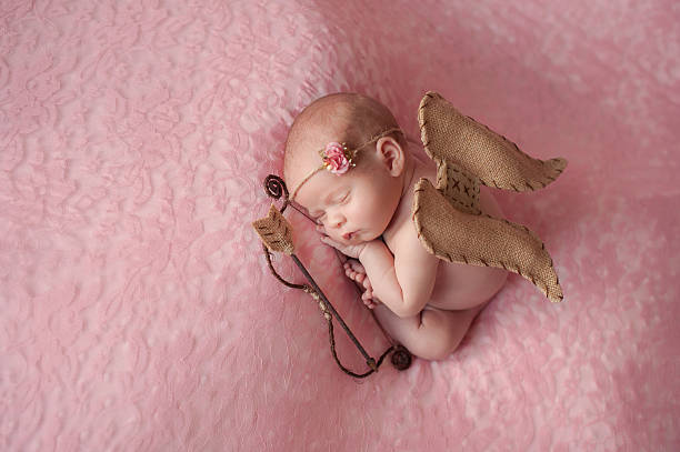 Newborn Baby Girl Wearing Cupid Wings stock photo