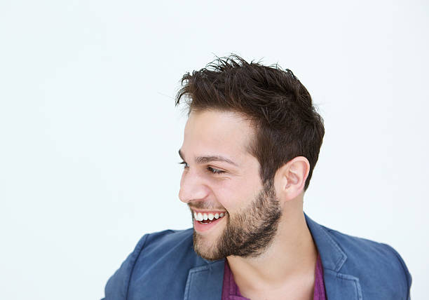 istock Trendy young man smiling on white background 517528555