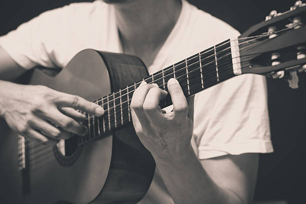 istock musician plays acoustic, classical guitar 517532337