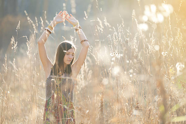 istock Girl in the grass in the setting sun 517533086