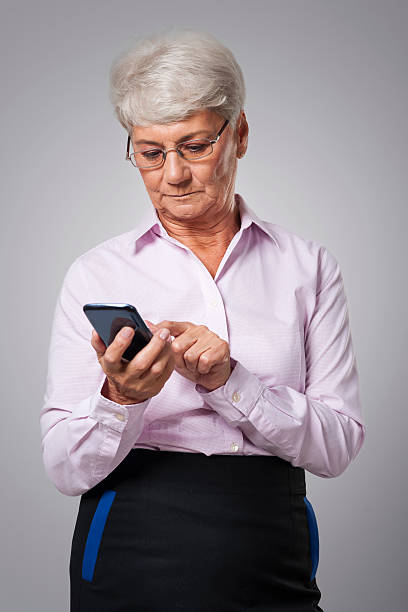 istock Pensive senior business woman using smart phone 517533395