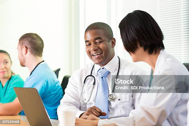 Diverse Doctors In Medical Staff Meeting Stock Photo - Download Image Now - Administrator, Cheerful, Doctor