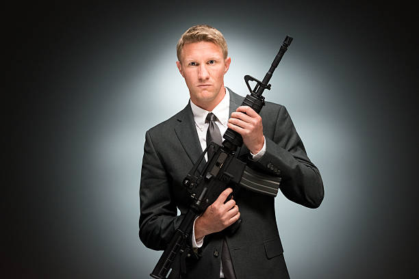 Businessman holding rifle