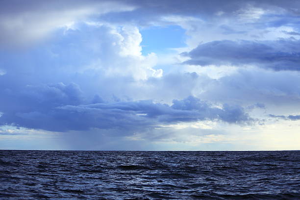 istock Cloudy dark sky above a surface of the sea 517534319