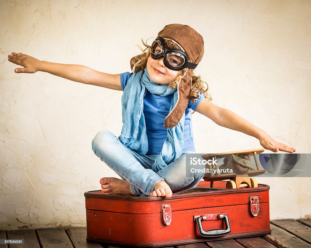 Imagination Happy kid playing with toy airplane Child Stock Photo