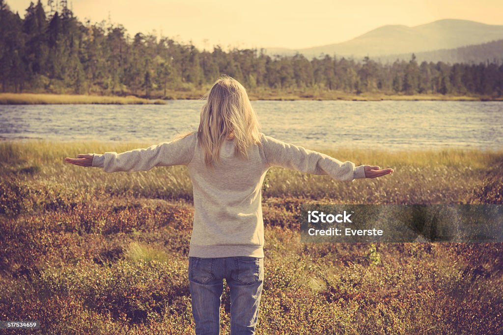Young Woman relaxing outdoor hand raised Lifestyle vacations concept Young Woman relaxing outdoor hand raised Lifestyle vacations concept forest and lake on background trendy retro colors Active Lifestyle Stock Photo
