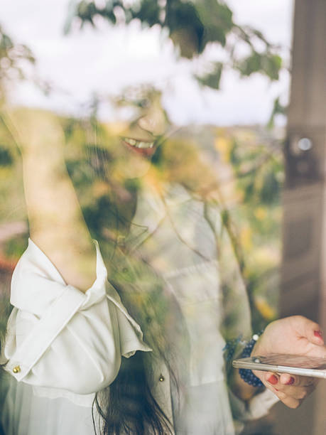 istock standing asian woman checking phone messages 517534832