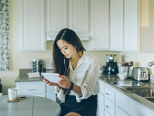 istock asian woman listening music with tablet pc 517535344