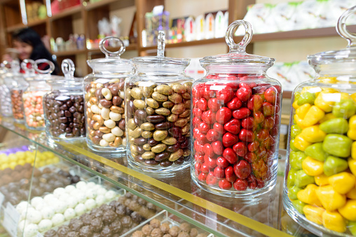 Candies in glass jars in candy shop