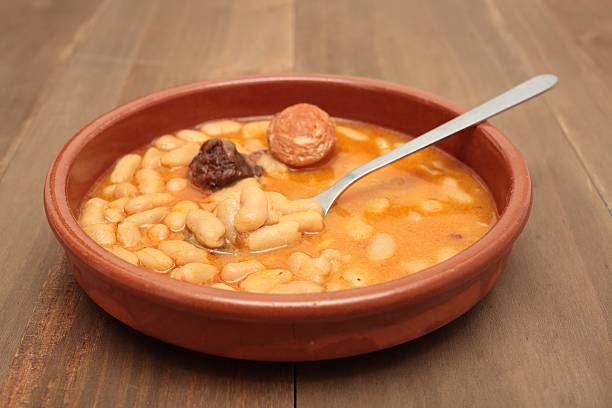 istock Asturian bean stew in a clay pot. 517542218