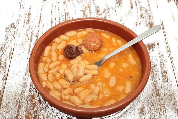 istock Asturian bean stew in a clay pot. 517542232