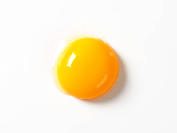 Raw egg yolk Raw egg yolk on white background egg yolk on white stock pictures, royalty-free photos & images