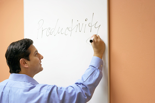 Businessman scribbling on a whiteboard