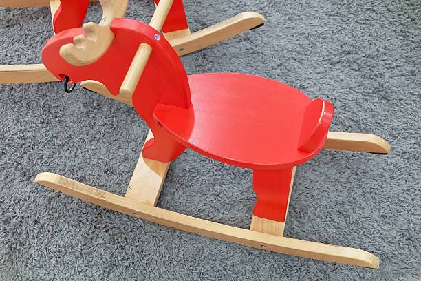 istock Red Wooden Rocking Reindeer on Gray Carpet 517546442