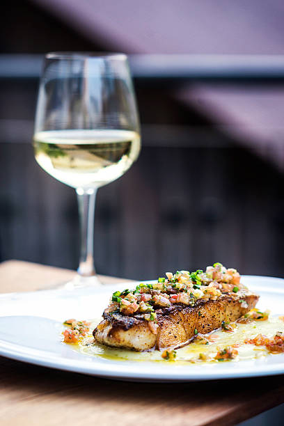 istock sea bass fish with mexican salsa sauce 517547928