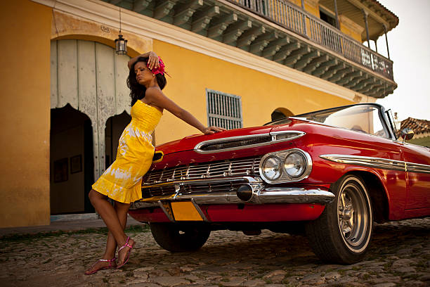 istock Beautiful woman posing with a red car 517549341