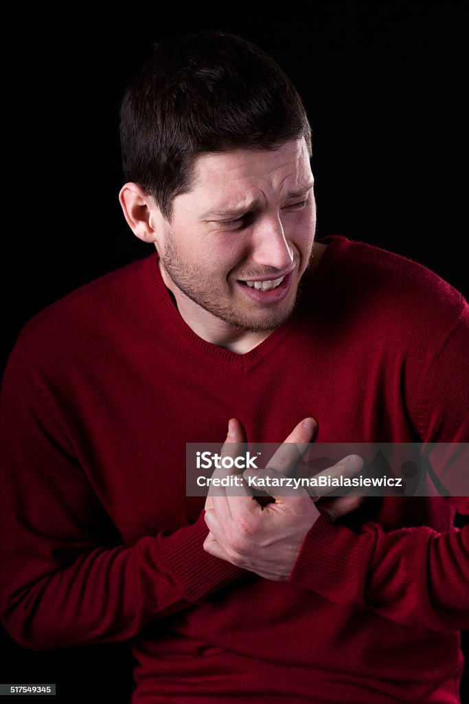 Heart attack Closeup of young man having heart attack Acute Angle Stock Photo