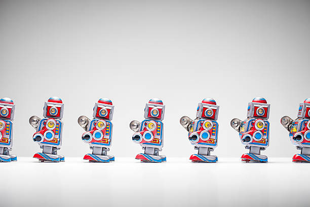 istock Retro tin toy robots standing in a row 517549461