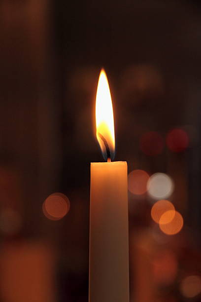 istock One candles in church as background 517549639