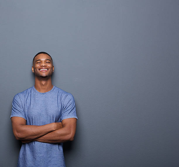 istock Handsome african american man laughing with arms crossed 517549773