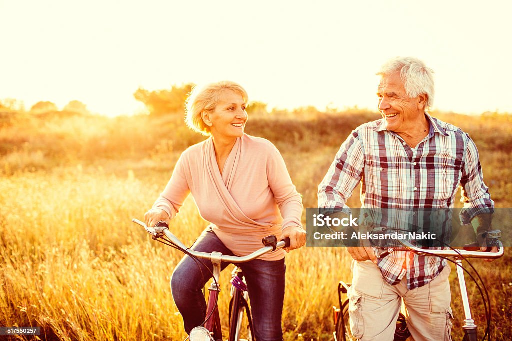 Active in their golden years Smiling senior couple riding bicycles  Senior Adult Stock Photo