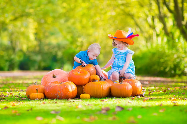 istock Adorable children at pumpkin patch 517552473