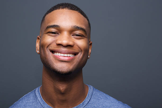 istock Happy black man smiling on gray background 517553777