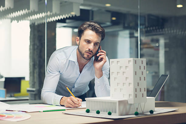 istock Designer talking on smart phone in office. 517554193