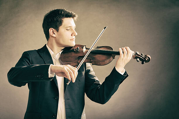 istock Man violinist playing violin. Classical music art 517554409